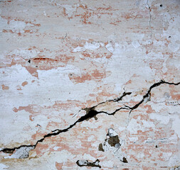 background texture of old wall with scuffed plaster and big crack