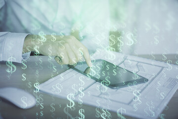 Double exposure of man's hands holding and using a digital device and forex graph drawing. Financial market concept.
