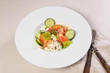 Quick and healthy food recipes. Salad with salmon, vegetables, herbs and capers on white plate. Mediterranean dish recipes. Selective focus. Close up