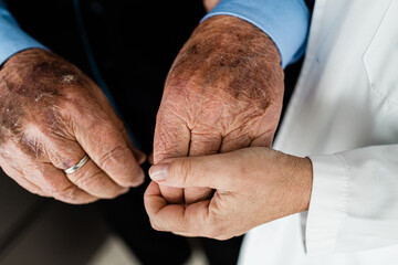 Fototapeta premium Nurse holding the hands of an elderly man