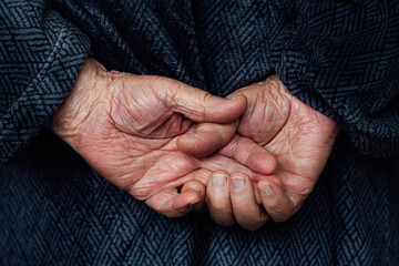 Fototapeta premium Older man's hands interlocked at the back