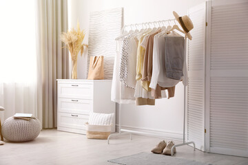 Dressing room interior with stylish white furniture