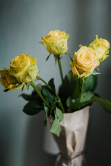 Bouquet of yellow roses on a gray backgroun