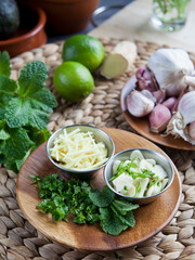 Sliced garlic and ginger with healthy herbs -  coriander, mint and lime -  healthy diet ingredients with Asian inspiration.