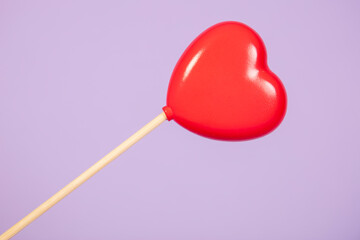 heart on a stick, isolated on purple background