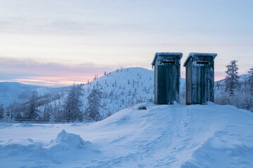 Evening landscape of snow-capped mountains and trees. Along the Kolyma highway To the coldest place on Earth - Oymyakon.