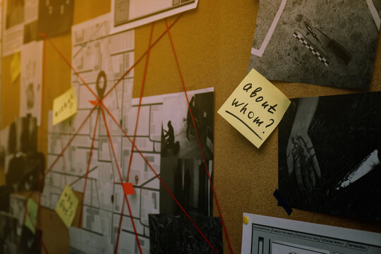 Detective board with map, crime scene photos and red threads, closeup