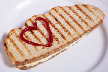 sandwich with drawn ketchup  hearts, close up top view