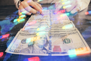 Double exposure of technology drawing hologram and us dollars bills and man hands. Data concept