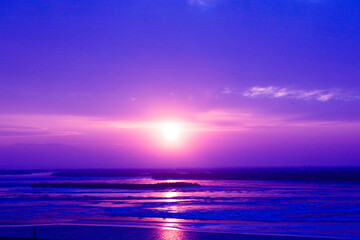 north winter cold sunset over a frozen river in pink and blue colors