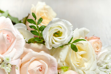 flower composition of light roses and eustoma close up. wedding day greeting card.