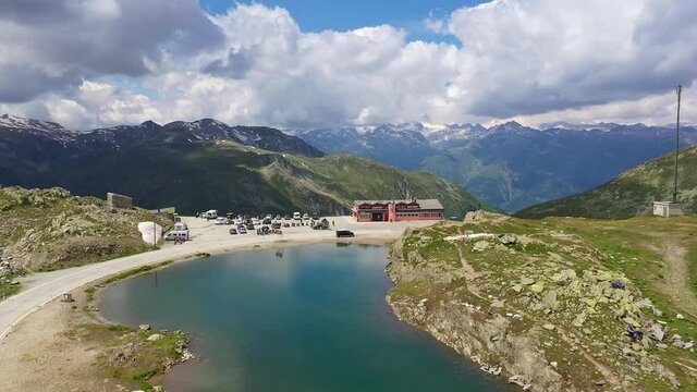 Aerial drone footage of the summit of the Nufenen pass between Cantons of Valais and Ticino in the alps in Switzerland