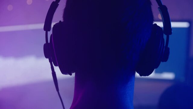 RGB gamer silhouette head with headphones listening to music 4K