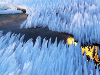 Snow melts under the influence of fire. Perfect reflection of the flame