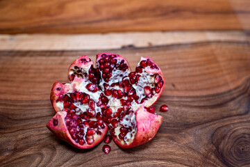 pomegranate seeds on wooden table