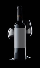 Bottle and glasses of red wine on a black background.