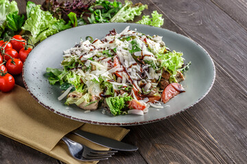 Green vegan salad from green leaves mix and vegetables. Top view. Salad recipes. Healthy vegan food.