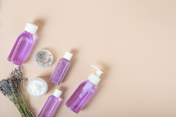 set of cosmetics with lavender on a beige background