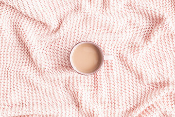 Plaid, cup of coffee on pink background. Flat lay, top view
