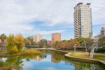 buildings and park with lake in downtown city in autumn