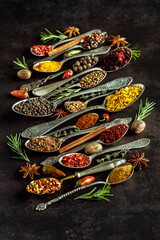 Various spices a vintage spoons on stone table. Colorful Herbal and Spices Oriental marketplace.Top view . Cafe concept. Delicious food delivery.