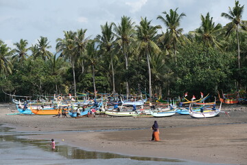 Fototapeta na wymiar Indonesia Bali Pekutatan - Pantai Medewi - Outrigger fishing boat Medewi Beach