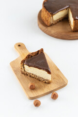 A slice of tofu cake with salted caramel and hazelnuts. Sugar, gluten and lactose free.