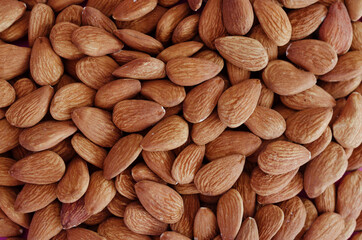 Background of almond close up, concept of vegetarianism and healthy lifestyle. Raw food. Flat lay. Top view. 