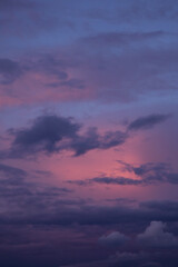 Sunrise, sunset pink violet blue sky with dark storm clouds background texture