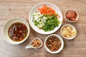 crispy fish with pork couple maw topping peanut in spicy and sour chili sauce salad on plate