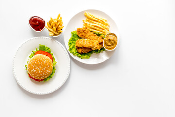Delicious burgers with french fries and fried chicken. Flat lay, top view
