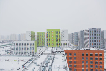 urban modern landscape: multi-colored new buildings residential buildings, windows, air conditioning, facades, roof in winter 