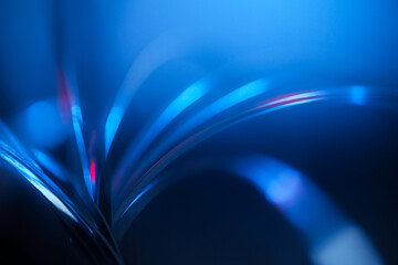 futuristic blurry abstract background in blue and red cinematic tones. strings, strips of arcs and with light highlights.