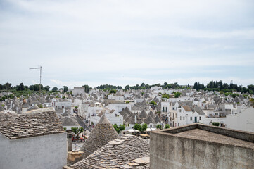 Obraz premium top view of Italian village Alberobello with Trulli house in Apulia, Italy. Unesco site in south of Italy. Italian culture lifestyle.