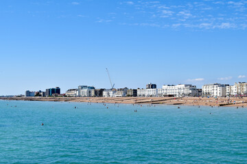 Worthing Beach UK, with people swimming in the sea