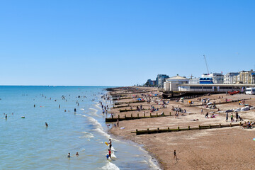 View of Worthing Beach UK, with people swimming in Summer