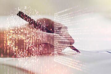 Creative code skull hologram and man hand writing in diary on background, cybercrime and hacking concept. Multiexposure