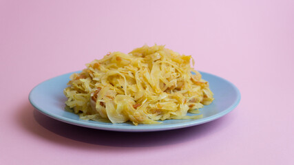 Stewed white cabbage on a plate. A dish of Russian cuisine. Garnish in the USSR.