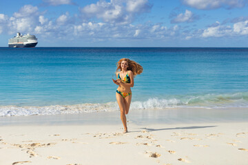 Fototapeta na wymiar woman in bikini runs on the beach