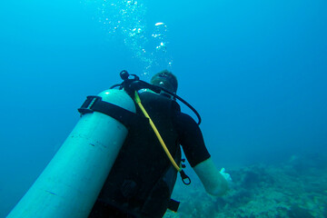 Diver in the ocean with aqualung. Adventure tourism. Diving concept.