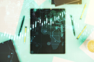Multi exposure of abstract financial diagram with world map and modern digital tablet on background, banking and accounting concept