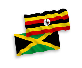 National vector fabric wave flags of Jamaica and Uganda isolated on white background. 1 to 2 proportion.