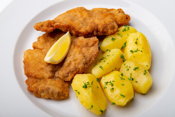 Pork chop with parsley potatoes and lemon
