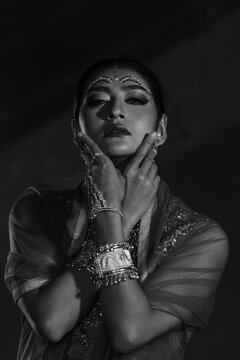 Portrait of beautiful indian girl with kundan jewelry set. Traditional India costume lehenga choli or sari, black and white.