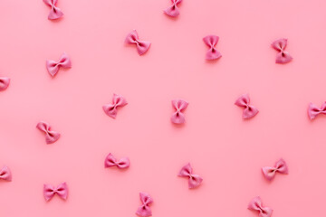Pasta pattern - colored farfalle, top view. Italian food background