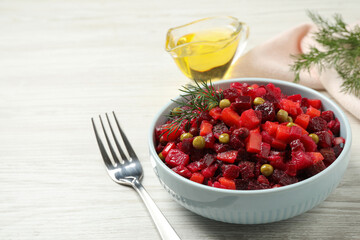 Traditional Russian salad vinaigrette served on white wooden table