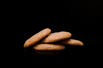 Almond cookies on dark background with copy space