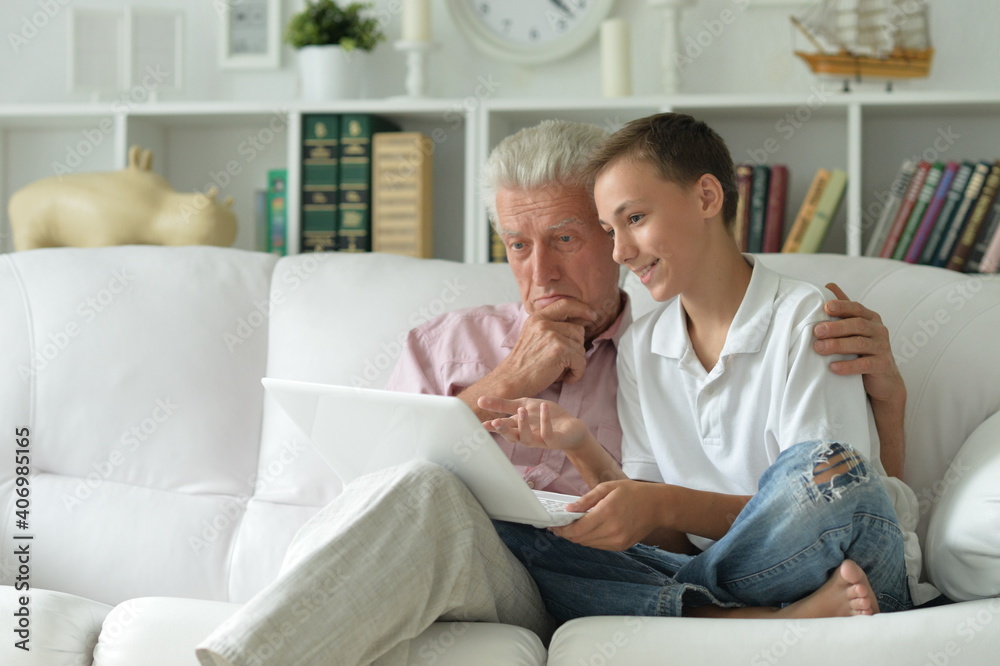 Sticker portrait of boy and grandfather with a laptop at home