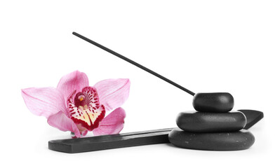 Incense stick in holder near orchid flower and spa stones on white background