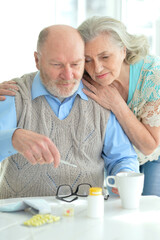 ill Senior couple with pills